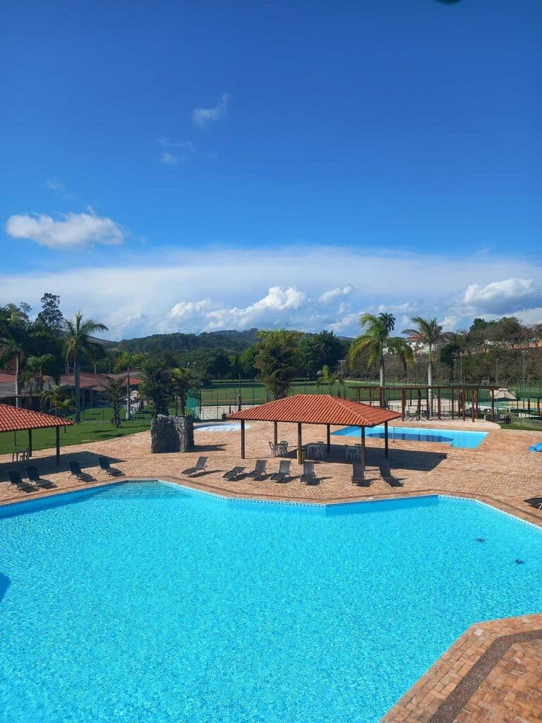 Conjunto de piscinas e quiosques do Sabbia Club em dia de sol
